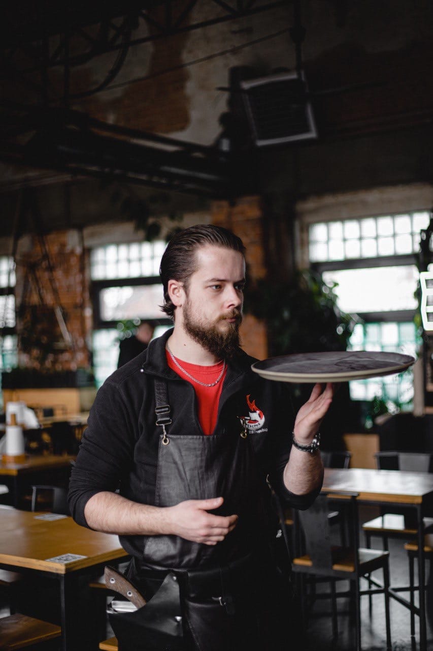 Restaurant Rebernia waiter in Lindström clothes.