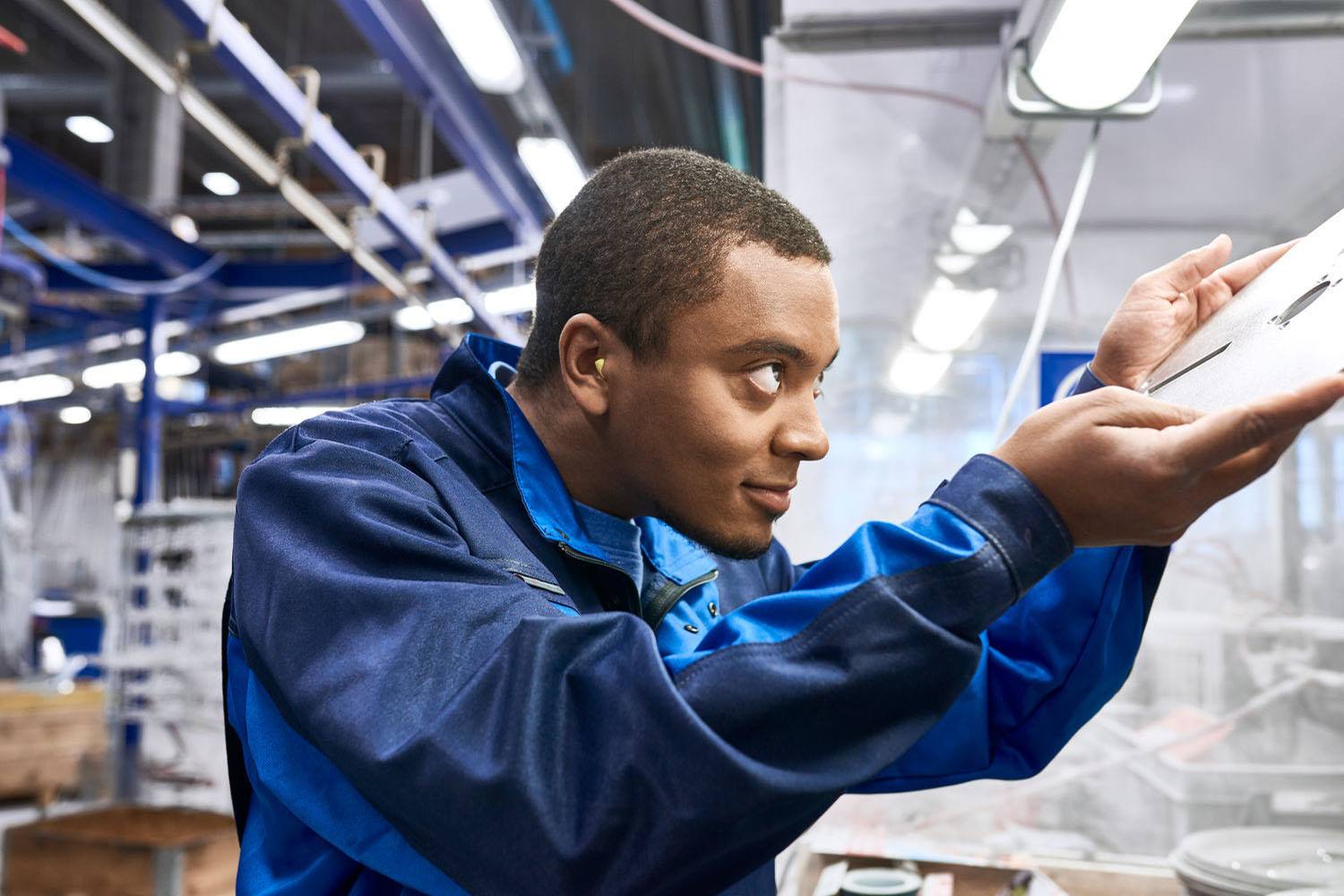 Engineer working in a manufacturing environment wearing his antistatic workwear